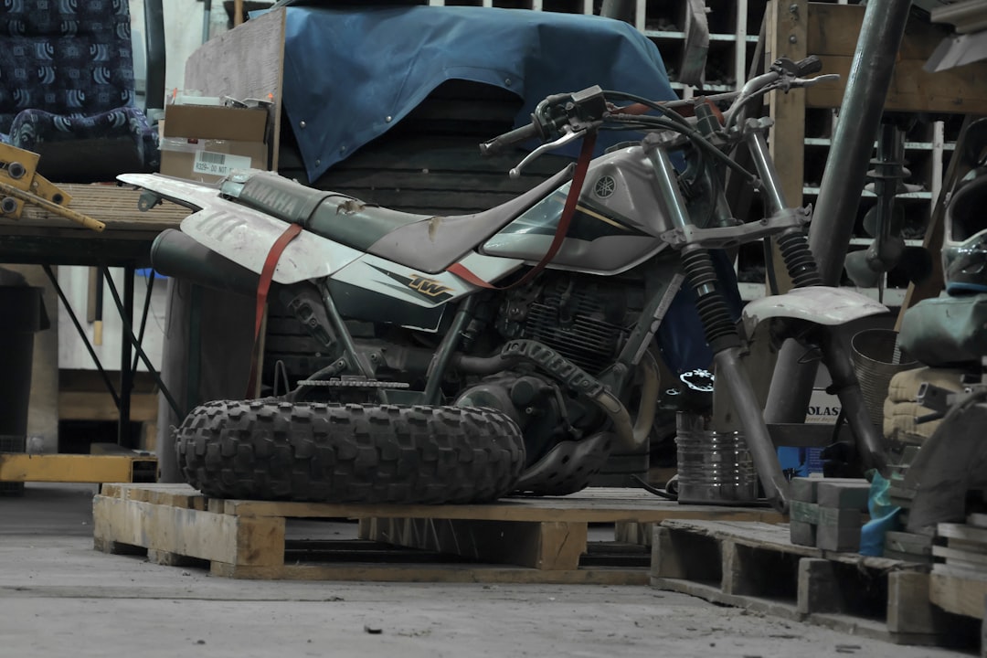 a-dirt-bike-sitting-on-top-of-a-wooden-pallet-yqvaien9obs